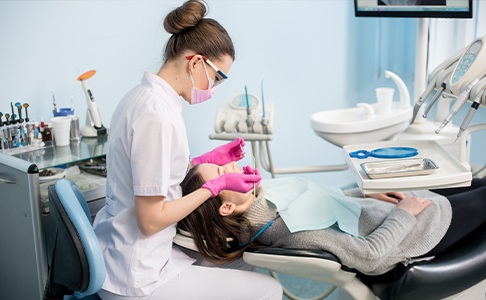 Dental team member treating patient