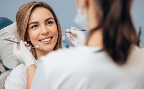 Woman receiving preventive dentistry checkup and teeth cleaning