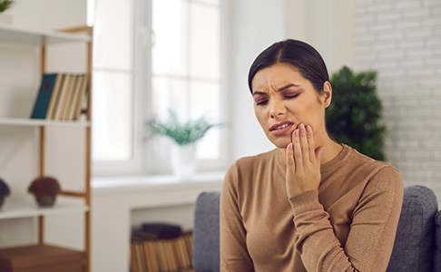 Woman leaning back in dental chair after dental implant salvage in Las Vegas, NV