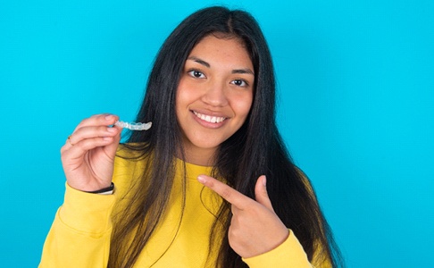 woman pointing at clear aligners for Invisalign in Las Vegas