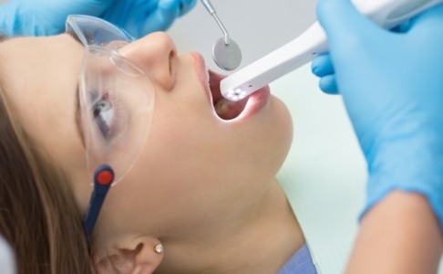 Dentist using intraoral camera to capture smile photos