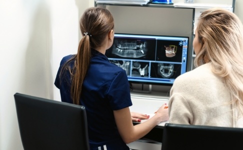 Dental team member reviewing all digital dental x-rays on computer screen