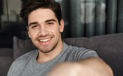 man smiling after getting veneers in Las Vegas