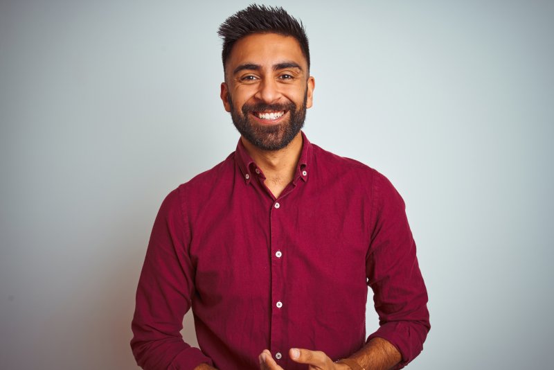 person smiling after veneer replacement