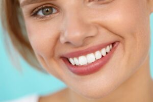 Nose to chin view of a woman with hazel eyes smiling