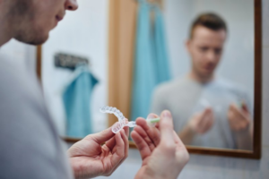 Man applying whitening agent to his take-home tray